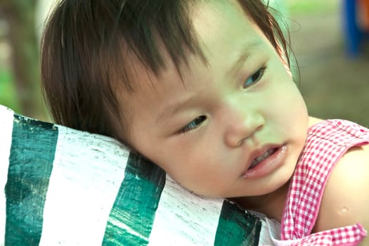 A Happy Asian Little baby girl flower on White Uniform of playground