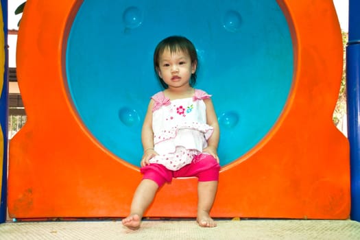 A Happy Asian Little baby girl flower on White Uniform of playground