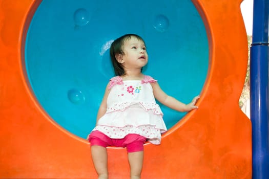 A Happy Asian Little baby girl flower on White Uniform of playground