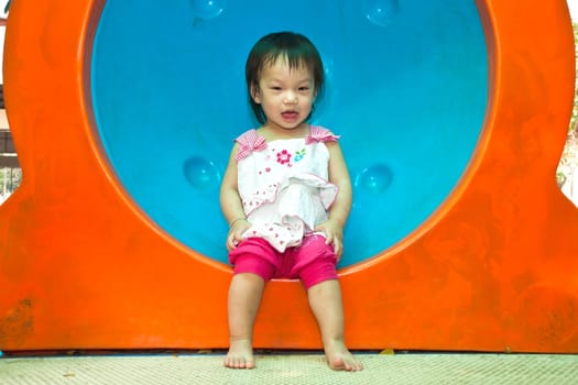 A Happy Asian Little baby girl flower on White Uniform of playground