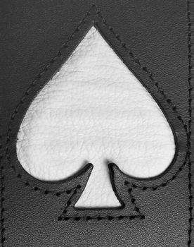 Spades symbol stitched in leather close up