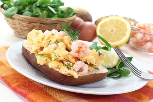 Scrambled eggs on toast with shrimp, dill and corn salad