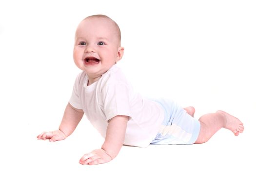 the little boy lies on a stomach and smiles. it is isolated on a white background. double 2