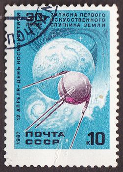 USSR - CIRCA 1987: A post stamp printed in USSR shows  Sputnik 1  first Soviet  artificial satellite orbits Earth , circa 1987