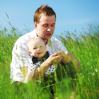 father and son in the grass