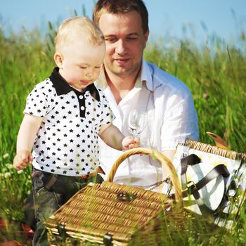 father and son in the grass