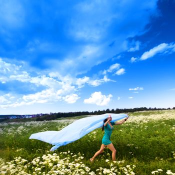  girl run by field fabric in hands fly behind like wings