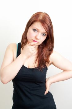 Brunette woman in black is thinking on white background