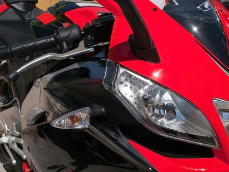 detail of front side of red motorbike 