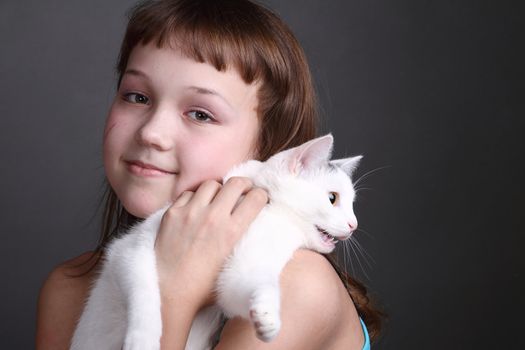 the girl and white cat play. close up. double 9