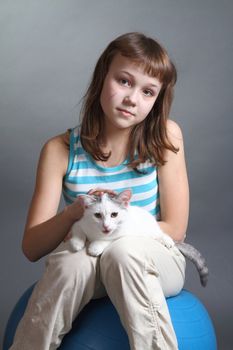 the girl and white cat play. close up. double 16