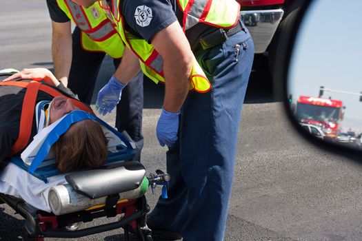 Ambulance nurses with insured man on gurney