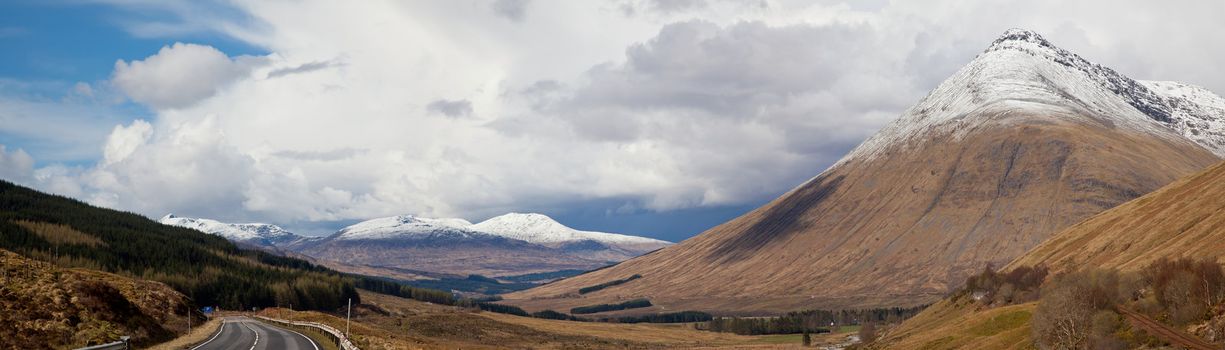 Panorama Empty Countryside Road Highway of Highlands Scotland with Beautiful Snow Mountain Range
