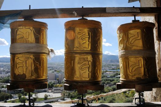 Golden prayer wheels in a historic Tibetan lamasery
