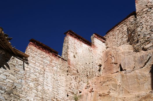 Landmark of typical historic Tibetan buildings against blue sky