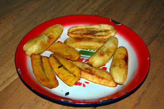 Fried banana at red metal plate, Papua New Guinea