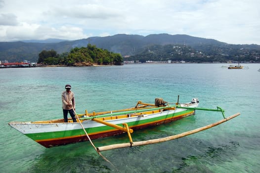 Man at fishing boat, Jayapura, Indonesia