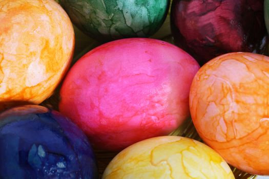 Collection of colourful marbled Easter Eggs in the colours of the rainbow or spectrum, close up view