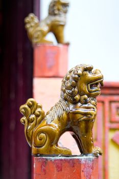 Ceramic Foo Lion Statues on Posts Outside Chinese Temple