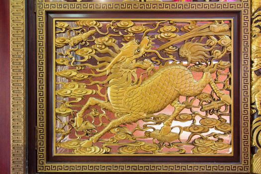 Gold Gilt Wood Carving of Qilin on Chinese Temple Wall in Chinatown