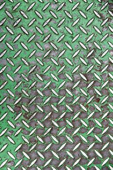 A metal floor background. Tiled steel with green a paint.