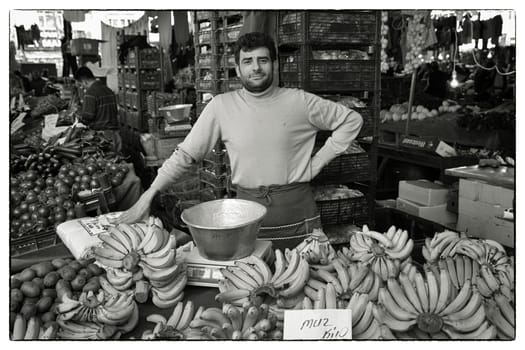 FRUIT VENDOR EYUP, ISTANBUL, TURKEY, APRIL 13, 2012: Proud banana salesman on the weekly Friday market in Eyup, Istanbul, Turkey.