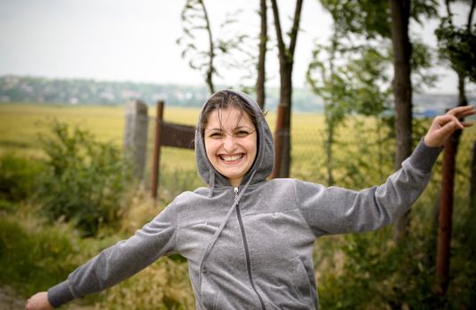 Girl with happy face running in nature