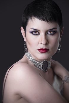 A portrait of a glamorous woman with jewelry on dark bacground