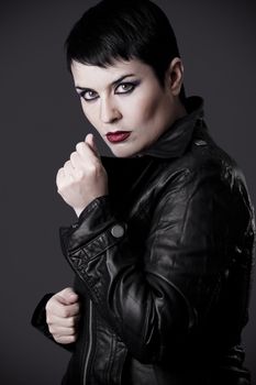 beautiful woman in black leather jacket, studio shot