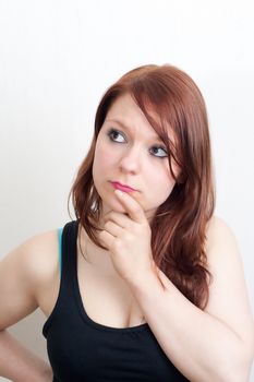 Brunette woman in black is thinking on white background