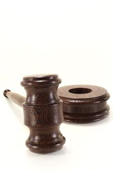 a brown judge's gavel on a white background