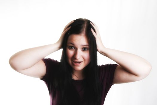 young blackhaired woman throw her hands up in horror 