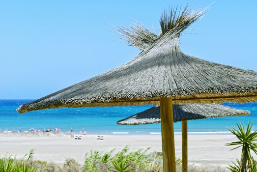 Beach umbrellas, blue sky and blue ocean.  Fuerteventura, Spain