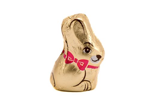 Chocolate bunny Easter symbol in foil isolated on white background.