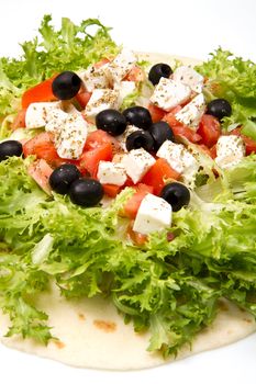 vegetarian piadina with fresh salad, tomatoes, olives and mozzarella cheese