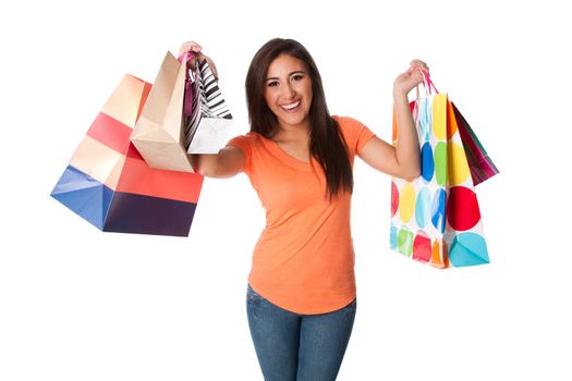Beautiful Happy smiling young woman on shopping spree carrying colorful bags with merchandise celebrating, isolated.