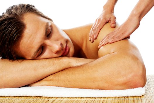 Close-up of an attractive man enjoying a back massage in a spa center