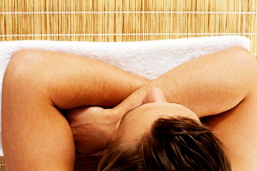 Top view of young man relaxing before spa on carpet