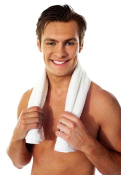 Portrait of a smiling man with towel around his neck after a workout on white background
