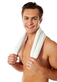 Sexy attractive smiling male with towel around his neck isolated over white