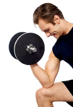 Portrait of young fit trainer working out with dumbbells isolated over white