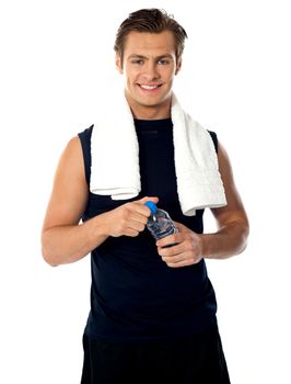 Young athlete posing with bottle of mineral water