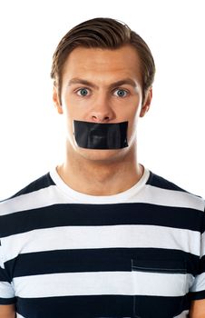 Closeup of a worried man. Mouth covered with duct tape