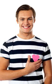 Smiling casual man with a paper heart isolated against white