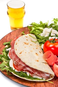 italian piadina with ham, fresh salad and mozzarella cheese