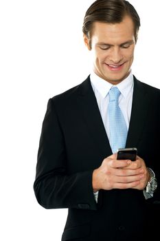 Confident businessperson messaging and smiling