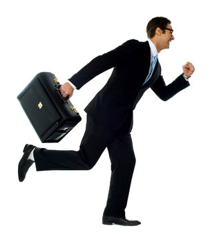 Professional man in running a posture with briefcase. Studio shot