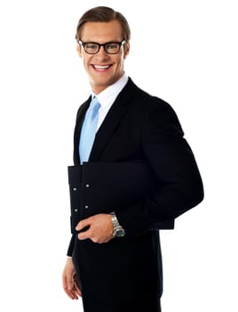 Successful young businessmale posing with documents. Side view, studio shot