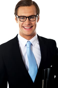 Closeup of smiling corporate young man isolated against white background