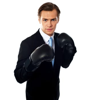Handsome businessman posing in boxing gloves over white background